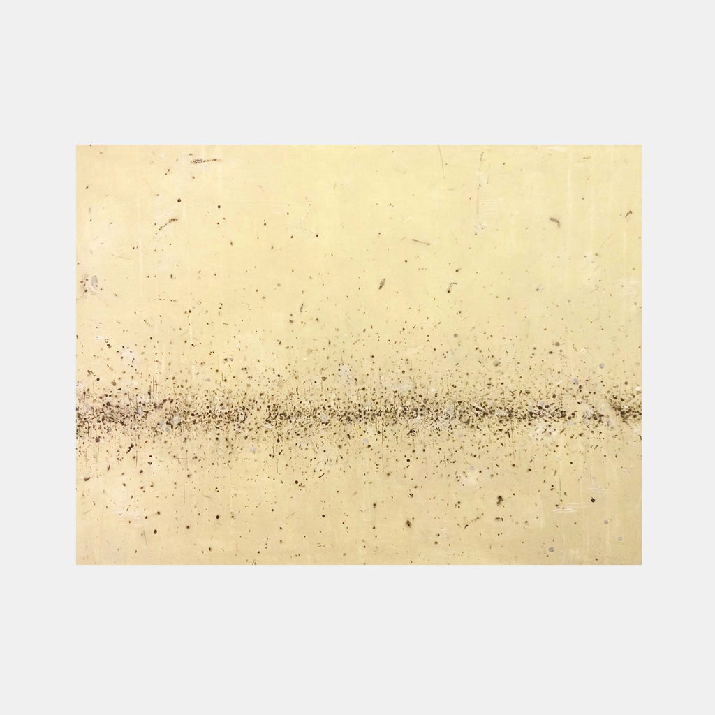 The artwork 'Rice' by Shira Toren features a minimalist horizontal composition with fine graphite particles scattered across a pale cream-colored Venetian plaster surface. A concentrated band of dark specks creates a central horizon line, dispersing outward like scattered grains, creating a subtle tension between order and chaos on the 36x48 inch canvas.