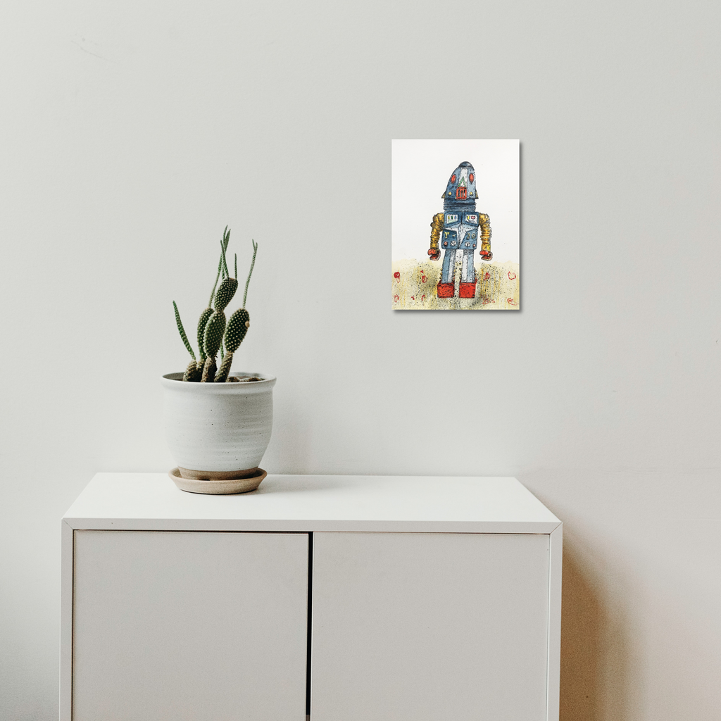 The artwork 'Robot T - 20' by Andrew Chan features a charming vintage-style robot rendered in ink and watercolor. The robot has a metallic blue body, cylindrical form, and delicate details against a soft beige background with subtle floral elements. The whimsical illustration combines precise linework with gentle watercolor washes, displayed as a 12x9 inch wall art piece.