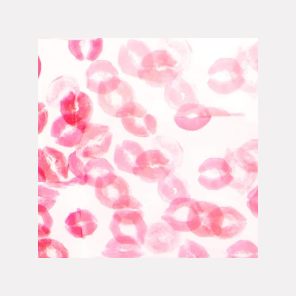 The artwork 'Sealed with a kiss 1' by Ronit Levin Delgado features multiple pink lipstick impressions scattered across a white canvas. The delicate lip marks create an abstract pattern, varying in intensity from bold fuchsia to soft rose tints, showcasing the unique texture and impression of lipstick as an artistic medium, 10x10 inches.