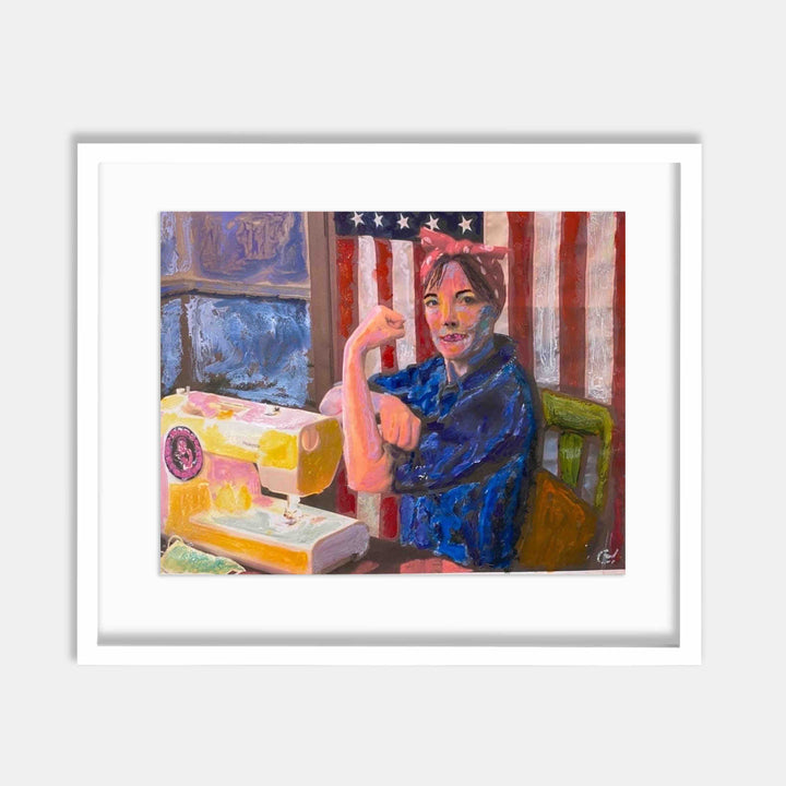 The artwork 'Rosie The Mask Maker' by Camilla Webster depicts a figure in a vibrant blue robe seated before an American flag backdrop. A sewing machine and bright yellow fabric materials are arranged on a wooden table, capturing the spirit of domestic craftsmanship during challenging times. The composition features expressive brushstrokes and rich colors in an impressionistic style, printed on fine art paper.
