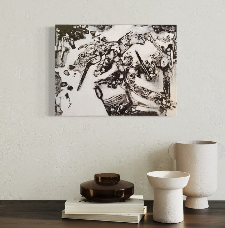 The artwork 'Running Aground' by James Ehling features a striking black and white abstract composition in acrylic. Dynamic swirling patterns create a sense of movement across the canvas, with bold contrasting shapes merging and flowing into each other. The monochromatic palette emphasizes the dramatic interplay between light and shadow, displaying organic forms reminiscent of natural phenomena. By James Ehling.