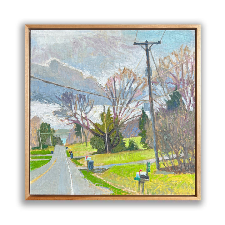 The artwork 'Outgoing' by Justin Shull depicts a serene suburban street scene with telephone poles and mailboxes along a winding road. The oil painting captures spring colors with blooming trees in soft pink and purple hues against a pale blue sky. Verdant green lawns and foliage complement the rural landscape, rendered in expressive brushstrokes on linen panel. By Justin Shull.