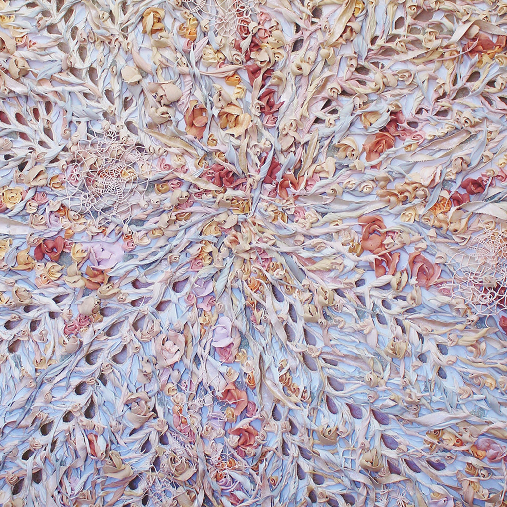 The artwork 'Ghost' by Seren Morey features an intricate radial pattern of layered, organic forms in pale blue, soft pink, and coral tones. Textured with glass beads and cut canvas, the ultralight acrylic composition creates a delicate, ethereal effect reminiscent of frost crystals or coral formations, spanning 66 x 60 inches. Seren Morey.