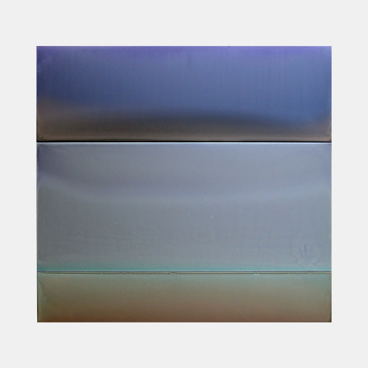 The artwork 'Shadow Light' by Susan English features horizontal bands of gradient colors transitioning from deep navy blue at the top, through misty gray in the middle, to a soft earth-toned base. The minimalist composition on aluminum showcases smooth tinted polymer surfaces creating subtle atmospheric depth and ethereal color transitions.