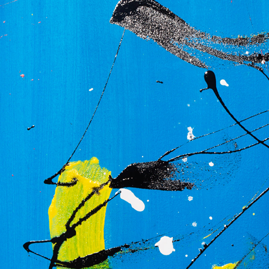 The artwork 'Sinking Below' features bold abstract elements with dynamic black splashes against a vibrant azure blue background. A striking yellow brushstroke emerges centrally, creating dramatic contrast. White speckles dot the composition, suggesting movement and depth. The acrylic and enamel painting demonstrates expressive brushwork and artistic spontaneity on canvas. By Cavier Coleman.