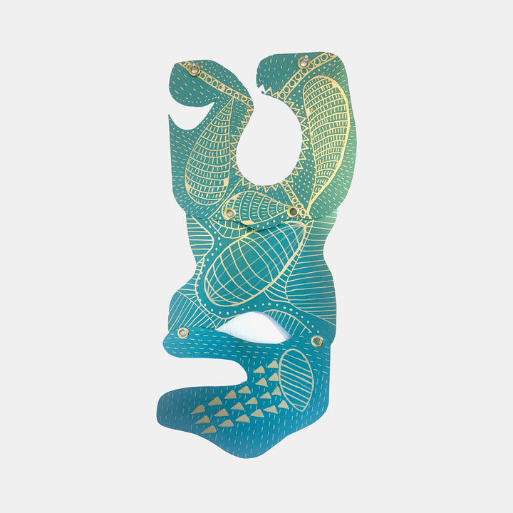 The artwork 'Sloth' by Sunny Chapman features an abstract sloth figure rendered in metallic teal and gold on premium paper. Intricate geometric patterns and textured line work create a modern interpretation, with curved shapes and detailed scales forming the creature's distinctive silhouette. The design combines organic flowing forms with structured patterns.