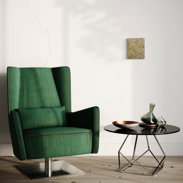The artwork 'Deflorees Origins Tulip 04' by Valerie Hallier features an elegant minimalist interior setting with a contemporary emerald green velvet wingback chair, positioned beside a modern round black side table with geometric metal base. Wall art with organic beige patterns visible in background. High-end furniture photography composition.