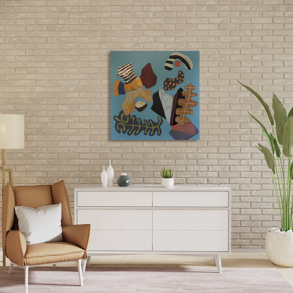 The artwork 'Something About Joy' by Karen Nielsen-Fried features abstract organic shapes in earthy browns, golds, and blacks arranged against a serene turquoise blue background. The composition includes curved leaf-like forms, striped patterns, and flowing lines creating a harmonious modern design on a 36x36 inch wood panel with acrylic paint.