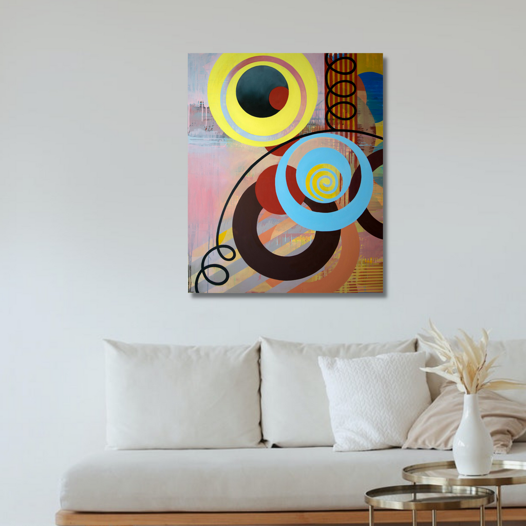 The artwork 'Spin' by Linda Schmidt features vibrant interlocking circles in yellow, blue, and brown against a soft pink background. Abstract geometric composition with spiral elements creates dynamic movement. Modern contemporary style oil painting showcases bold curves and organic shapes with subtle texture and layered colors on canvas.