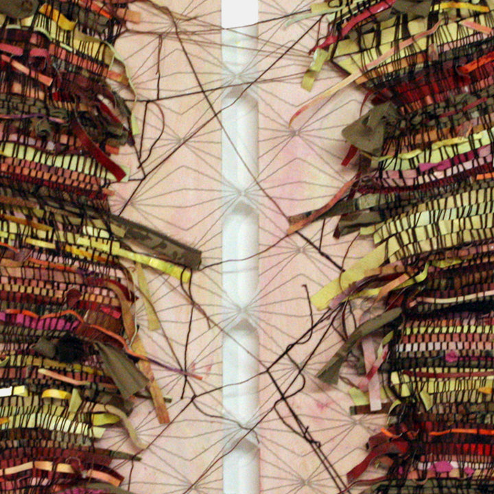 The artwork 'Still Holding On' by Christina Massey features an intricate mixed-media composition with woven textures in red, yellow, and olive tones. A central white vertical band divides the symmetrical piece, while delicate black threads create web-like patterns across the surface. The layered fabric, khakis, and yarn create a dynamic textural interplay.