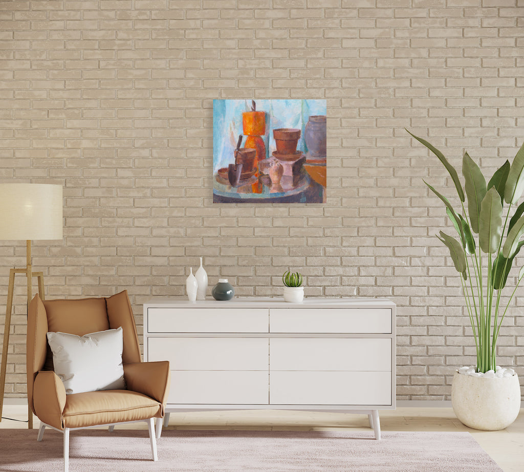 The artwork 'Still Life with Plant Pots' by Peter Colquhoun features a collection of terracotta and ceramic containers arranged on a circular surface against a soft blue background. A striking orange pot commands attention amid earthy brown vessels, while a small gardening trowel rests among the composition, creating a harmonious blend of warm tones and textures in this oil painting.