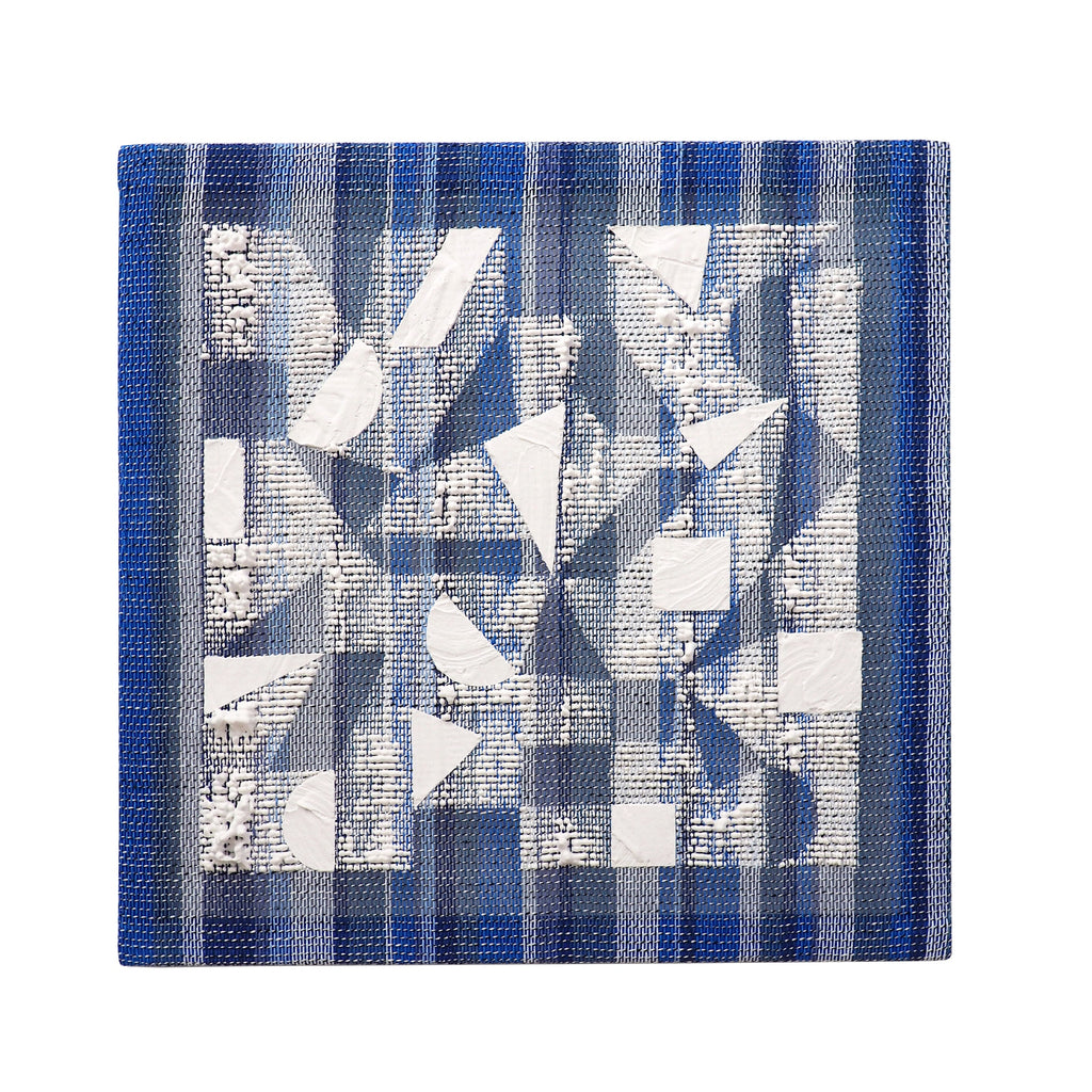 The artwork 'Stripe Shape' by Morgan Hale features a geometric composition of white triangular and rectangular forms arranged on a handwoven linen surface in varying shades of deep blue. The 15x15 inch piece combines plaster elements with textured fabric, creating a dynamic interplay of angular shapes and textile patterns. The design suggests movement through its structured yet organic arrangement.
