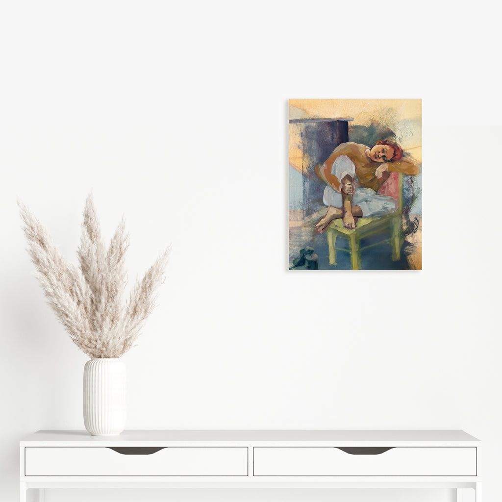 The artwork 'Studio Study' features a reclining figure on a green chair against a soft, impressionistic background of golden yellow and muted blues. The oil and Guerra painting combines loose brushstrokes with subtle color transitions, creating a contemplative atmosphere. The composition showcases expressive painting techniques and a masterful play of light and shadow. By Hanna Brody.