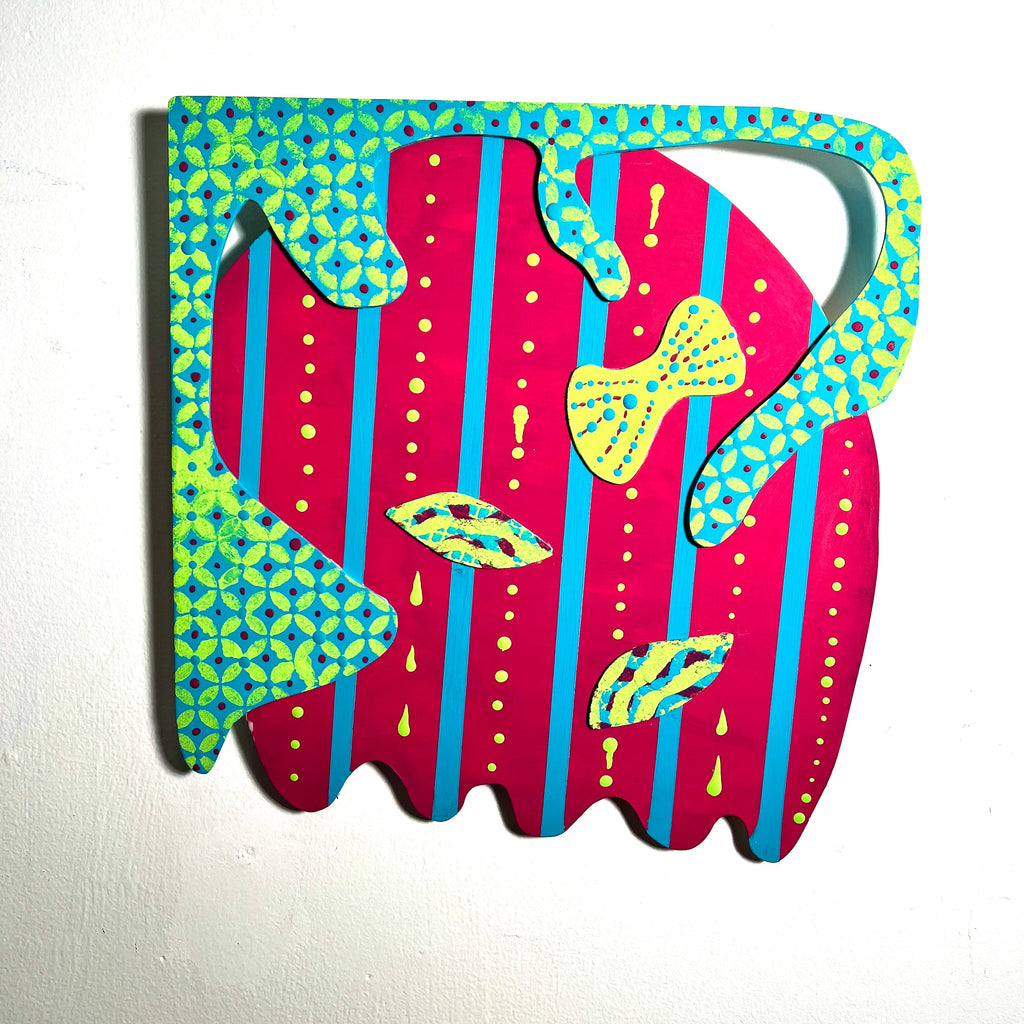 The artwork 'Feeling Pretty' features vibrant abstract shapes on wood, combining hot pink and turquoise geometric patterns. Bold vertical stripes in pink are adorned with yellow dotted accents and decorative bow motifs. A turquoise and lime green checkered border frames the whimsical composition. Created with matte acrylic on wood by Sunny Chapman.