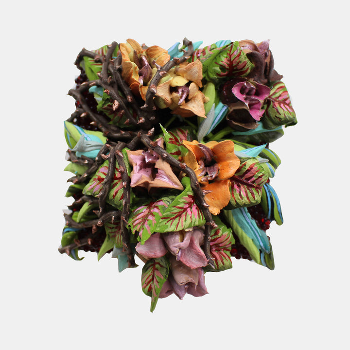 The artwork 'Synthede' by Seren Morey features a vibrant three-dimensional floral composition with layered acrylic elements. Rich browns, oranges, mauve pinks, and tropical greens create an organic texture. Glass beads and ultralight acrylic form intricate leaf and petal patterns, arranged in a square format with sculptural depth and botanical-inspired details.