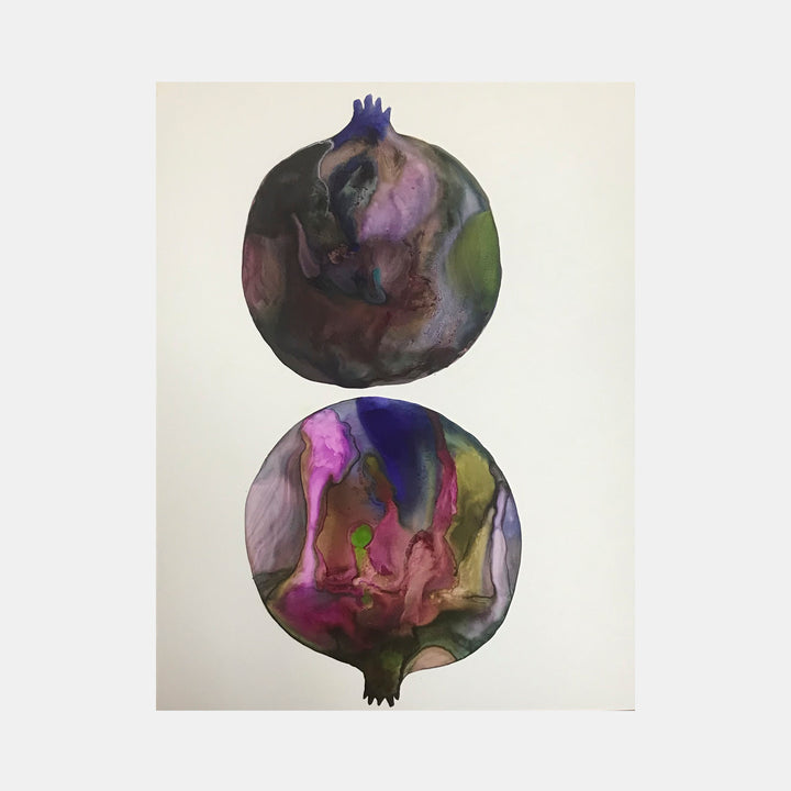 The artwork 'c1' by Arielle Stein features two circular pomegranate forms in fluid watercolor and acrylic ink. The top sphere shows deep purples and greens melding together, while the bottom displays vibrant pink, blue, and olive tones flowing in abstract patterns. Both forms are rendered on cream paper with delicate crown-like stems.