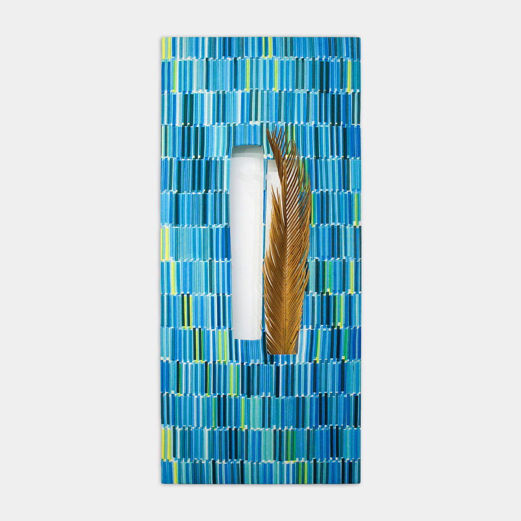 The artwork 'Composite 21' by Molly Koehn features a vertical geometric pattern of turquoise and aqua blue rectangles screen printed on raw silk, with a preserved golden brown dried plant element centered in a white negative space, creating a striking contrast between organic and geometric forms. 40x18 inches.