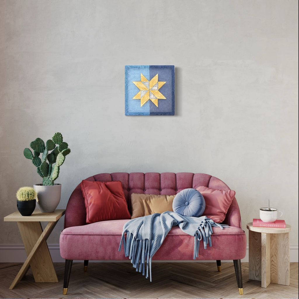 The artwork 'Memory' by Morgan Hale features a geometric star pattern in yellow tones against a blue background, handwoven in linen and plaster. This 15x15 inch piece showcases clean lines and precise craftsmanship, creating a striking contemporary folk art aesthetic with textural elements and crisp color contrast.