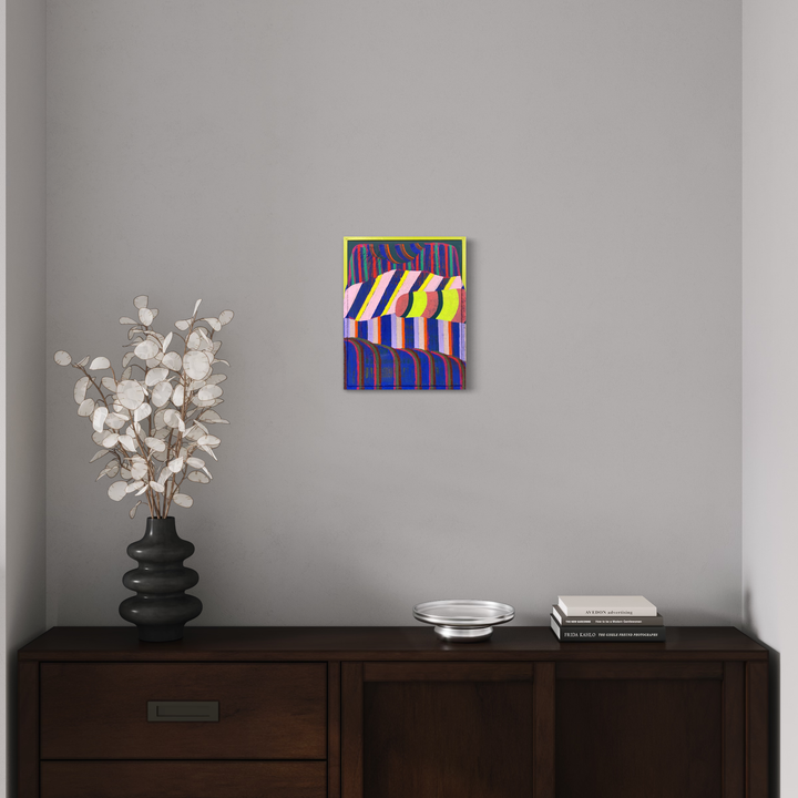 The artwork 'Velvet Water' by Natalie Lanese features bold geometric stripes in yellow and white against a deep blue background, creating a dynamic pattern with rhythmic vertical movement. The mixed media piece combines Flashe, acrylic, oil, and pumice, mounted in a found frame with a lime green border, displaying a modern abstract aesthetic.