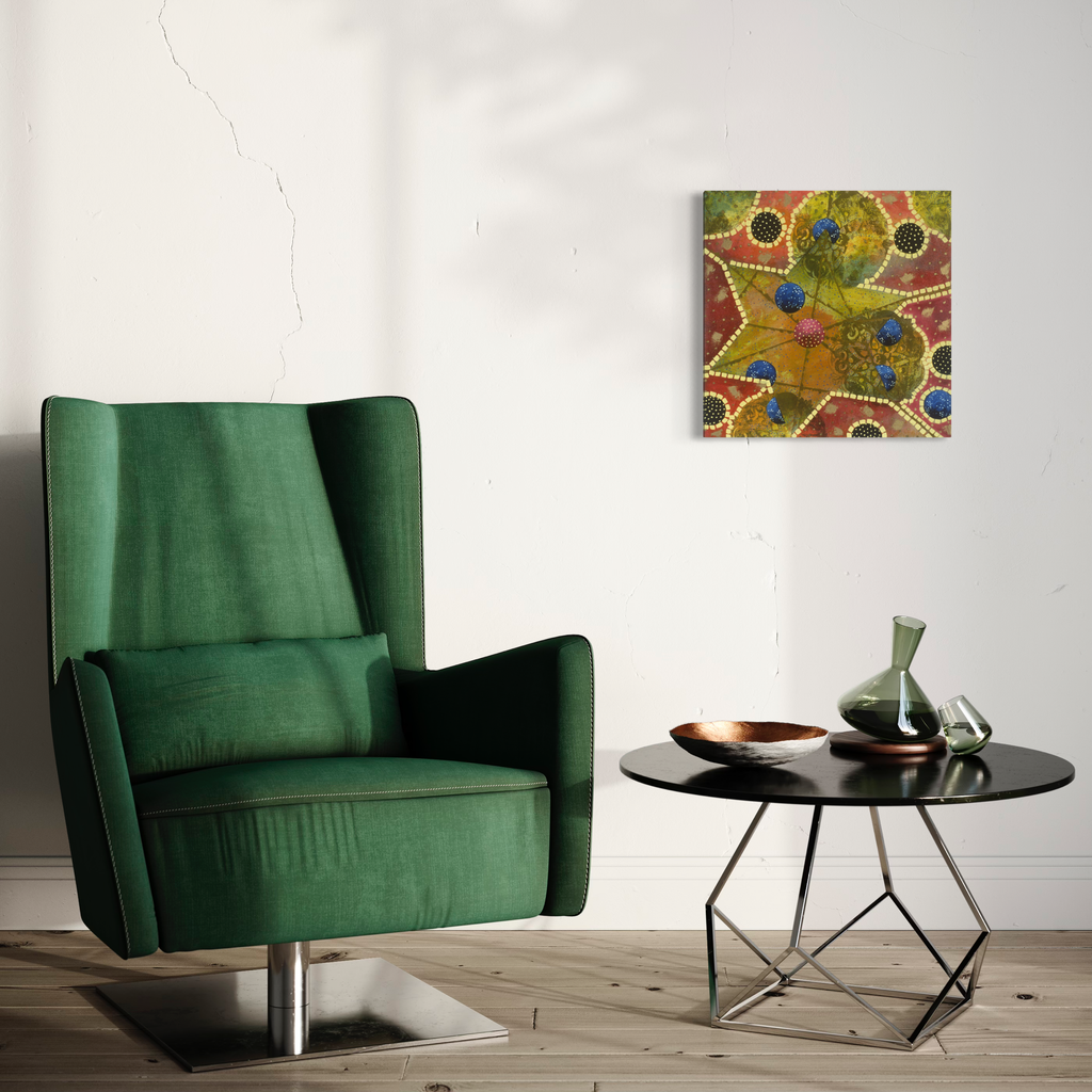 The artwork 'Faith in the Afternoon' by Amy Cheng features vibrant abstract circular patterns in olive green, rust orange, and deep blue, creating a mosaic-like composition. Delicate dotted lines connect organic shapes, displayed above an emerald green armchair and modern side table in a minimalist interior setting. Oil and silkscreen on canvas, 20x20 inches, by Amy Cheng.