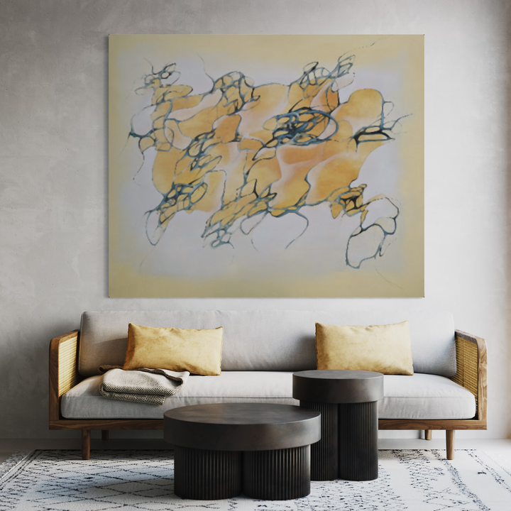 The artwork 'Raspberry Light' by Megan Olson features abstract flowing forms in warm golden yellow hues intertwined with dynamic blue linear elements against a pale cream background. Oil on linen canvas showcases gestural brushstrokes creating an ethereal, floating composition that spans 60 x 72 inches, displayed above a modern sofa setting. By Megan Olson.