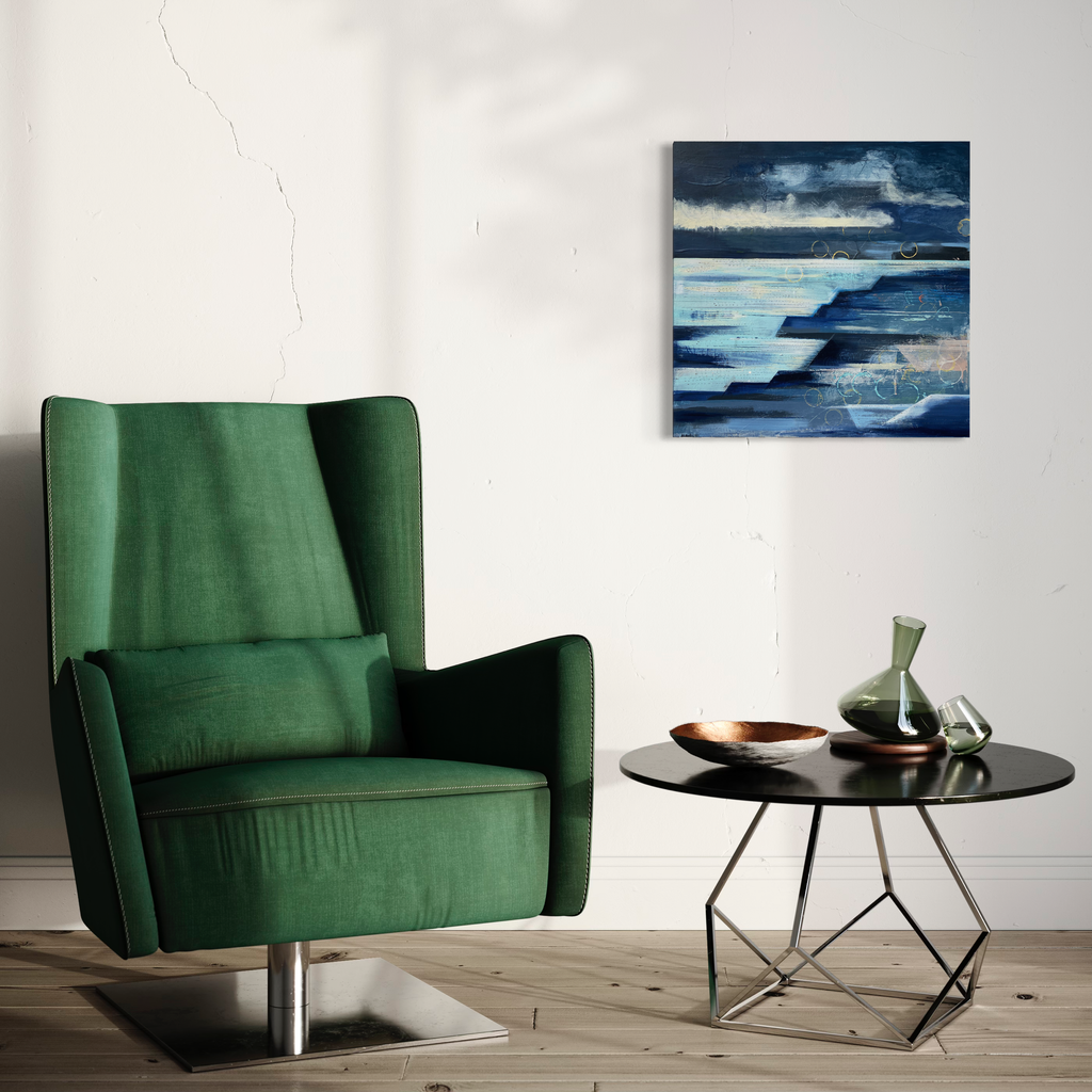 The artwork 'Horizon' by Nicki Adani features layered abstract landscape in deep navy and ice blue tones, creating a dramatic seascape effect. Horizontal brushstrokes suggest ocean waves and distant clouds, while textured mixed media on wood panel adds depth and movement, displayed in a modern setting with 24x24 inch dimensions. By Nicki Adani.
