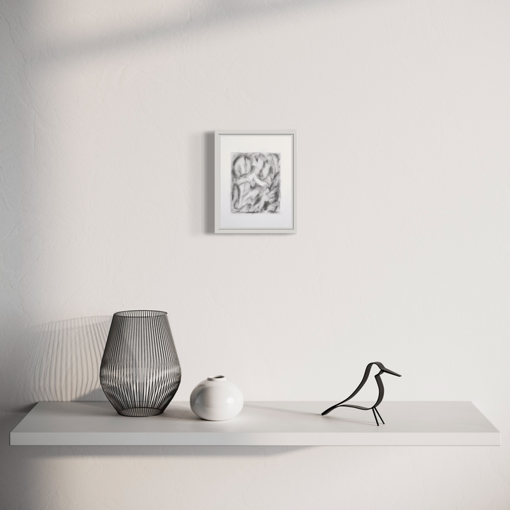 Interior emerge (1) by Diana Naccarato: Minimalist shelf display featuring abstract pencil artwork in white frame, accompanied by modern wire mesh vase, white ceramic sphere, and decorative bird figure. 8x6 inch framed pencil drawing mounted above sleek gray floating shelf against pristine white wall.