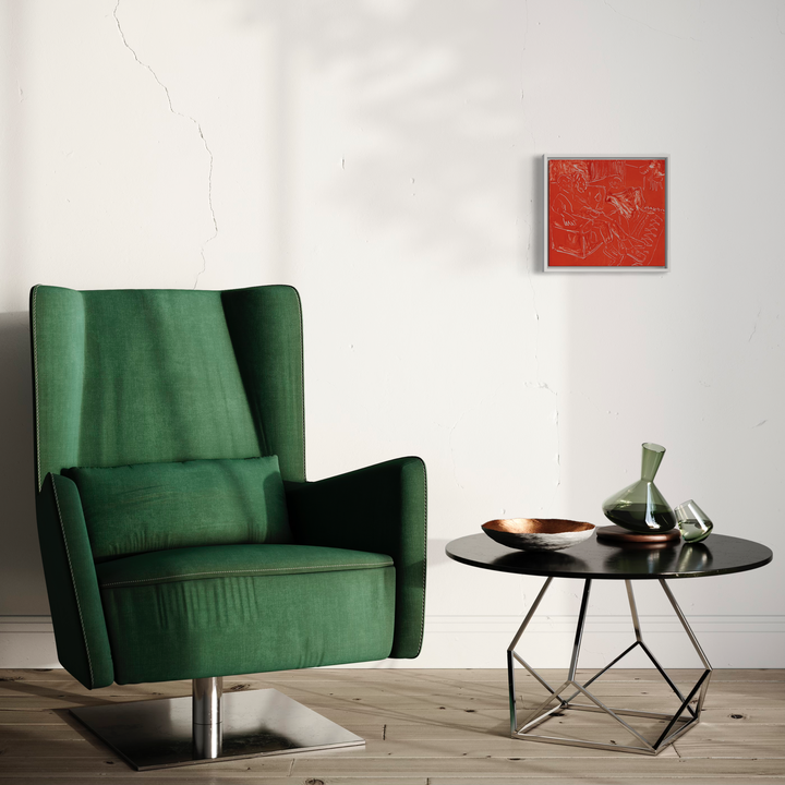 The artwork 'Red Living Room II' by Chelsie Sunde features a modern interior setting with an emerald green velvet wingback chair on a chrome base, positioned beside a geometric black side table with decorative vessels. A small red monotype print adorns the white wall, creating a minimalist contemporary aesthetic with natural wooden flooring.