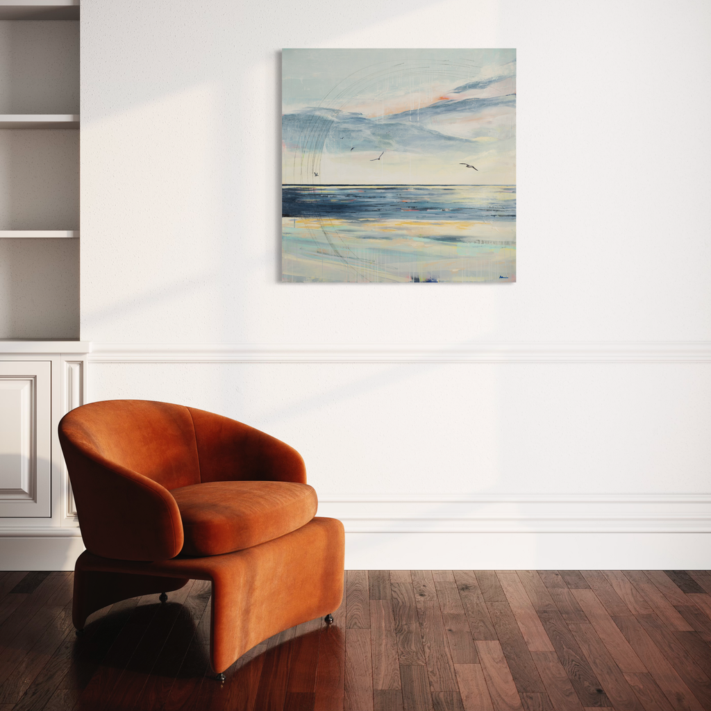 The artwork 'Serenity' by Nicki Adani features a tranquil coastal landscape rendered in mixed media on wood panel. Soft pastel blues and whites capture a misty seascape with distant birds in flight. The horizon line divides gentle cloud formations above from reflective waters below, creating a peaceful atmospheric composition. The 36x36 inch piece evokes a calming maritime atmosphere through its ethereal watercolor-like effects and delicate brush