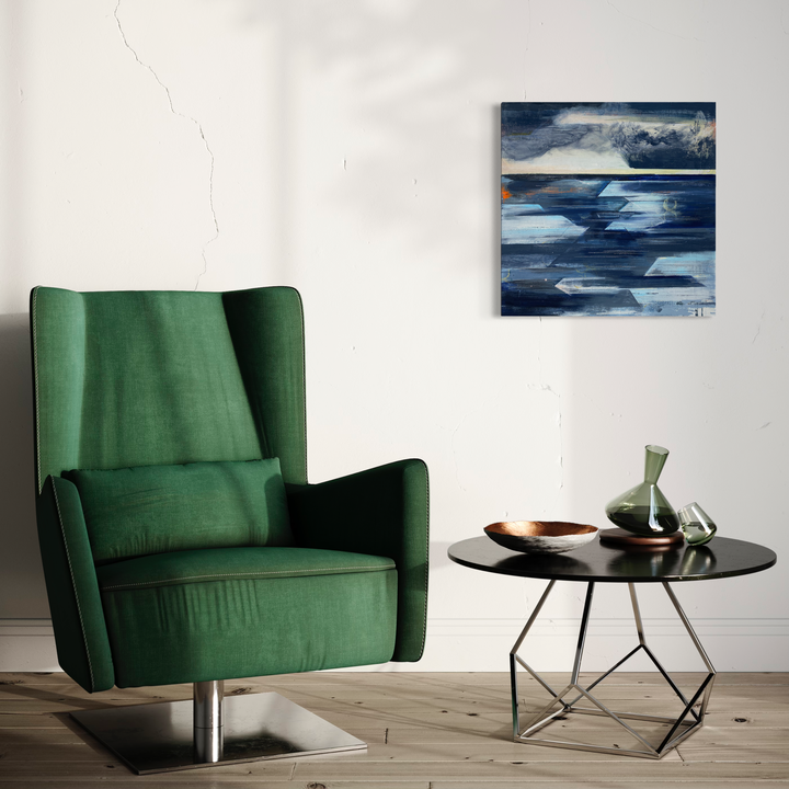 The artwork 'Stillness at the Horizon' by Nicki Adani features abstract geometric shapes in deep navy blues and whites, creating a dynamic seascape-inspired composition. Angular forms intersect with smooth brushstrokes, suggesting waves and cloudy skies. Mixed media on wood panel brings textural depth and movement to this 24x24 inch contemporary piece, capturing the serene atmosphere of an ocean horizon.