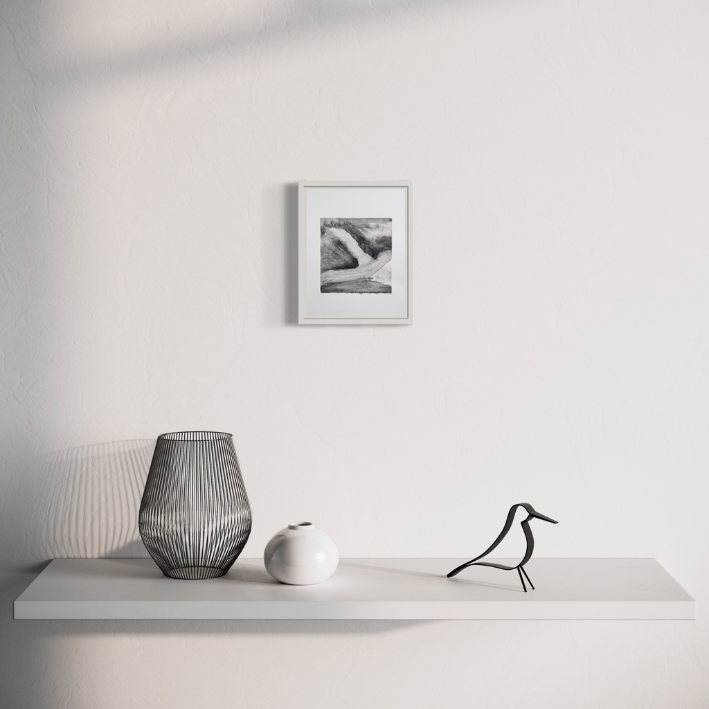 The artwork 'Storm' by Diana Naccarato features a minimalist display with a framed black and white pencil drawing above a white shelf, accompanied by contemporary decor including a wire-frame vase, white ceramic vessel, and decorative bird figure. Clean monochromatic composition in 8x6 inches. Created by Diana Naccarato.