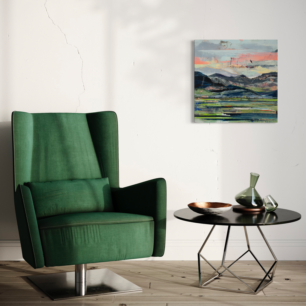 The artwork 'Traveling West' by Nicki Adani features a vibrant landscape with layered mountains against a sunset sky, rendered in mixed media on wood panel. Bold brushstrokes create rolling hills in shades of green and blue, while a coral-pink horizon glows above. Small birds soar across the atmospheric scene. 24x24 inches mixed media painting by Nicki Adani.