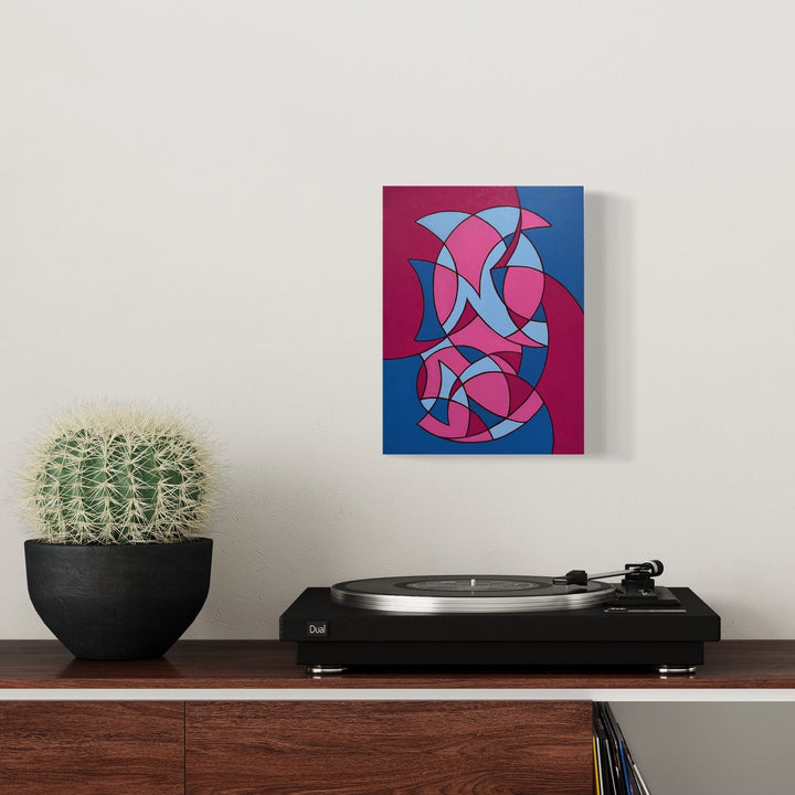 The artwork 'Fool's Remedy' by Joe Piscopia features an abstract geometric composition with interlocking curved shapes in vibrant magenta and electric blue. The design creates a dynamic flow of curved segments reminiscent of stained glass, painted in acrylic on a cradled panel, measuring 12x9 inches. By Joe Piscopia.