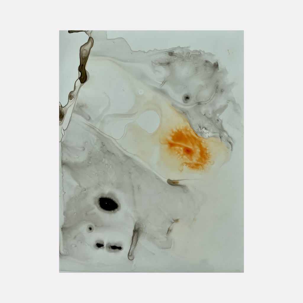The artwork 'Re.lease #11' by Dina AZ Salem features abstract fluid shapes in white, grey, and vibrant orange. The acrylic on yupo paper creates ethereal swirls and organic forms, with dark accents scattered throughout the composition. Delicate marbling effects give depth to the minimalist contemporary piece.