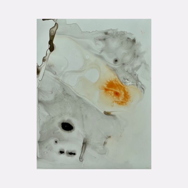 The artwork 'Re.lease #11' by Dina AZ Salem features abstract fluid shapes in white, grey, and vibrant orange. The acrylic on yupo paper creates ethereal swirls and organic forms, with dark accents scattered throughout the composition. Delicate marbling effects give depth to the minimalist contemporary piece.