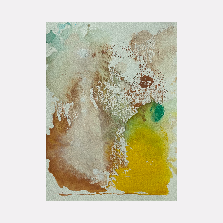 The artwork 'Re.lease #19' by Dina AZ Salem features abstract watercolor-like composition with ethereal blends of earthy brown, vibrant yellow, and subtle teal green hues. The acrylic on paper piece showcases organic textures and splatter effects, creating a dreamlike atmospheric quality with translucent layers and dynamic color transitions.
