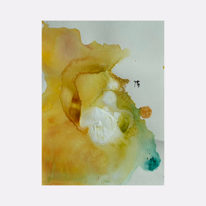 The artwork 'Re.lease #54' by Dina AZ Salem features ethereal watercolor-like acrylic washes in golden yellow and turquoise hues. Abstract organic shapes flow across white paper, creating translucent layers that blend and merge, with subtle color transitions and delicate edges reminiscent of natural mineral formations. The composition showcases fluid movement and luminous qualities.