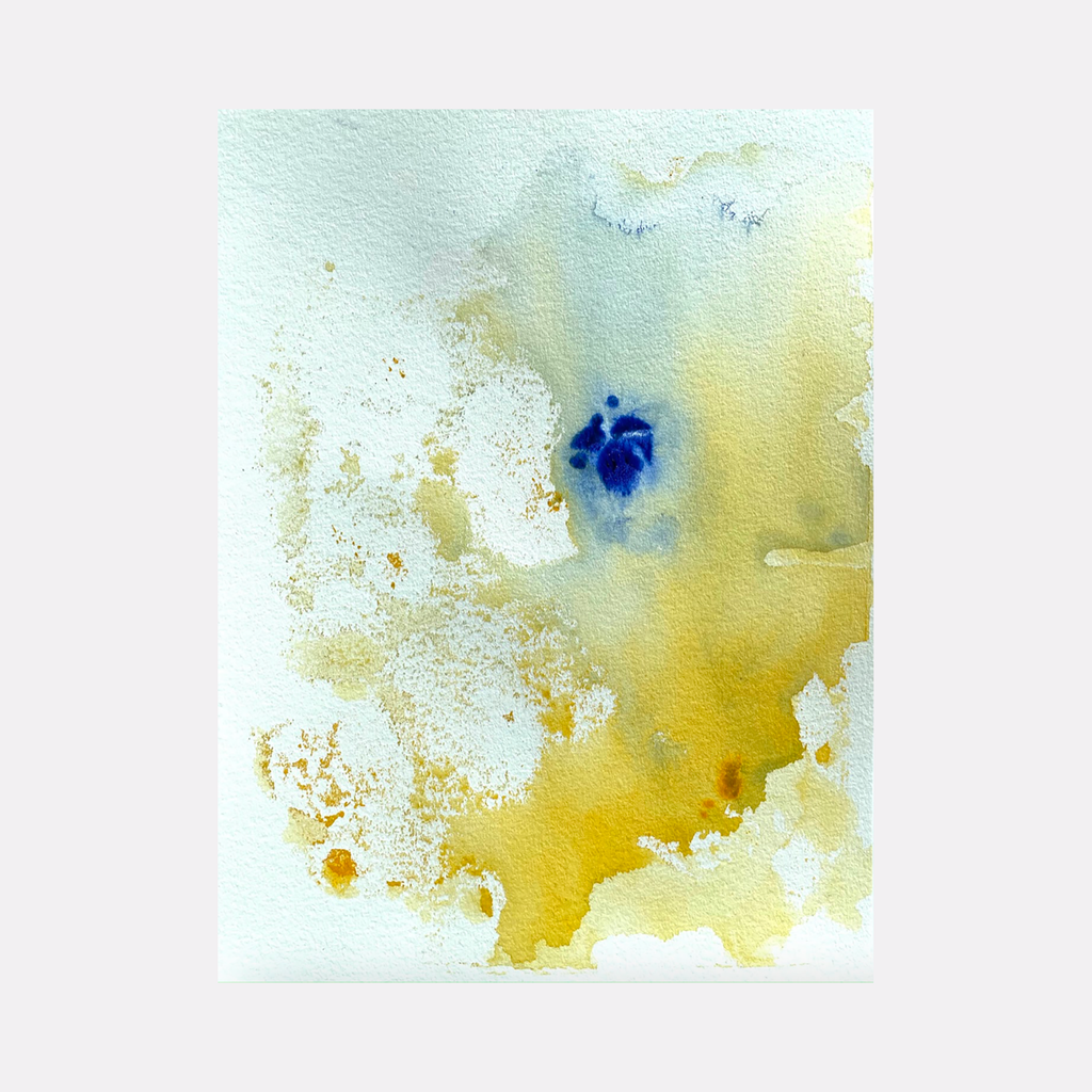 The artwork 'Re.lease #8' by Dina AZ Salem features ethereal watercolor-like effects in acrylic, with a striking deep blue focal point floating in a dreamy expanse of golden yellow and ivory white. The composition shows organic, fluid transitions between colors, creating a misty, atmospheric abstract landscape on paper by Dina AZ Salem.