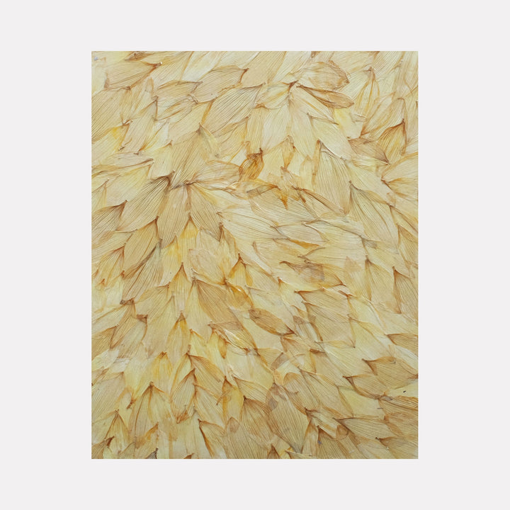 The artwork 'Deflorees Origins Sun Flower 01' features densely layered pale yellow flower petals arranged in an organic, overlapping pattern creating a textural abstract composition. The preserved petals are coated with polyurethane varnish on canvas, displaying subtle variations in cream and golden tones. Art by Valerie Hallier.