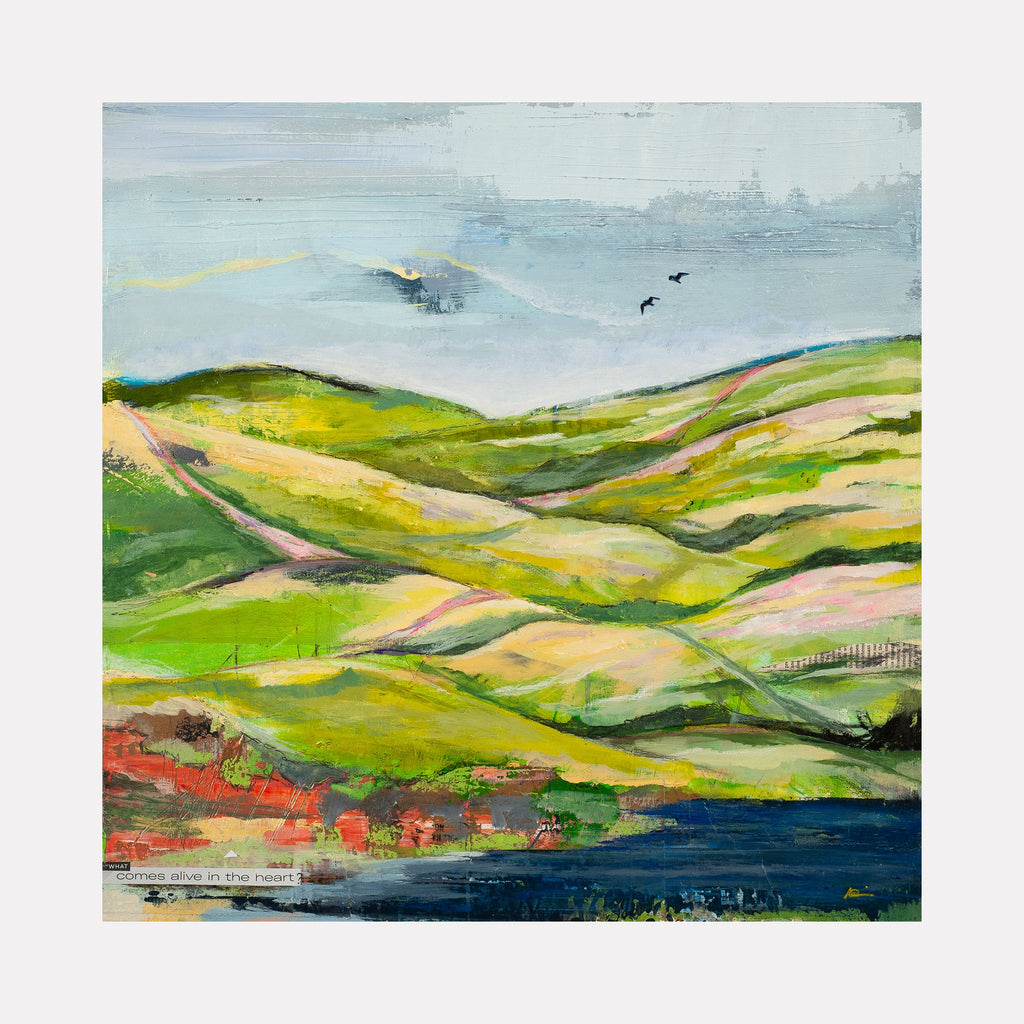The artwork 'Hills and Valleys #3' by Nicki Adani features a pastoral landscape with rolling verdant hills in vibrant greens and warm yellows, set against a misty blue sky. A deep blue water body rests at the base, with touches of red and coral along the shoreline. The mixed media painting on wood panel captures undulating terrain with a contemporary impressionist style.