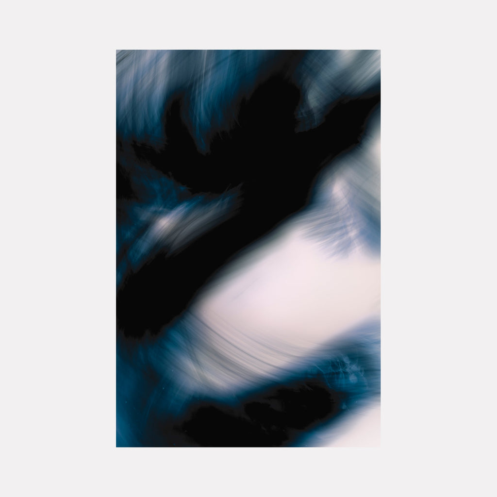 The artwork 'Indigo Dragon III' by Chunbum Park features abstract swirling patterns in deep indigo blue and black, contrasting with luminous white spaces. The motion-blur effect creates a dynamic, ethereal composition reminiscent of flowing water or windswept clouds, captured through digital photography with artistic long exposure techniques. Limited edition print by Chunbum Park.