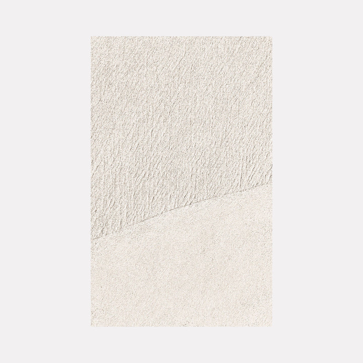 The artwork 'Serenity #1' by Fabienne Sowa-Dobkowski features a minimalist composition with subtle textural contrasts in cream and off-white tones. The image is divided diagonally, creating two distinct areas with different surface textures - one grainy and one smooth, evoking a sense of tranquility through its monochromatic palette.
