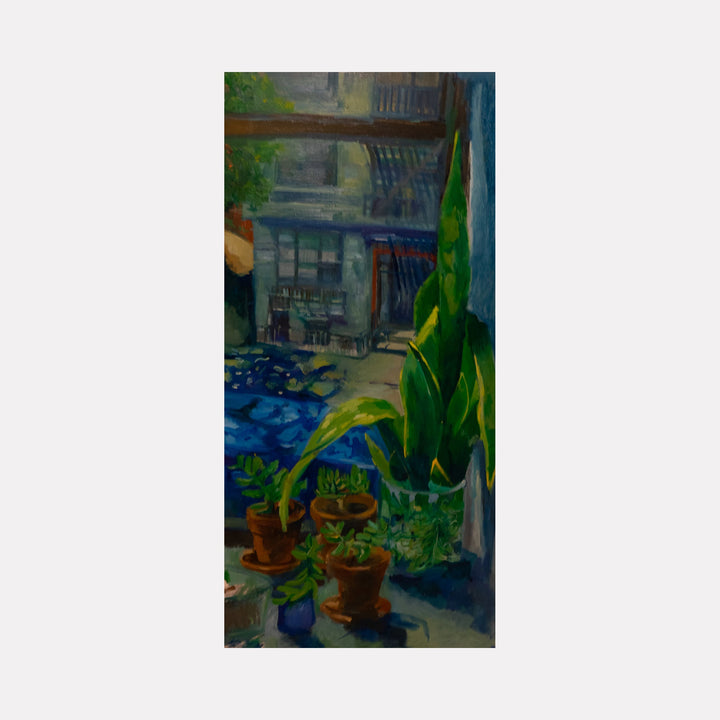 The artwork 'Snakes' by Darren Singer features a vibrant urban garden scene with lush green tropical plants in terracotta pots, set against a moody blue architectural backdrop. Oil painting on birch wood captures the interplay of natural and urban elements, with detailed foliage and atmospheric depth through shadowed doorways and balconies.