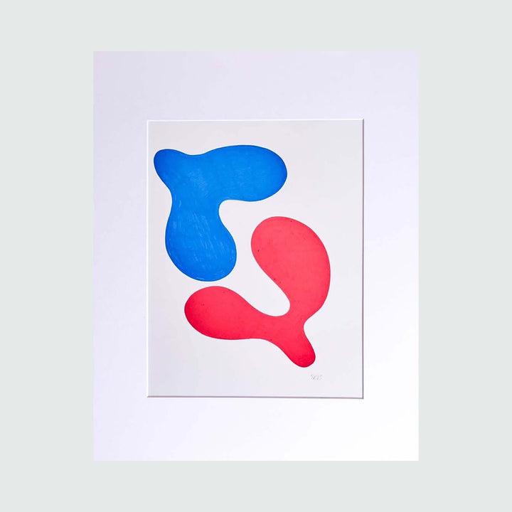 The Morning Meditation Series 8 by Shadia Sabagh features abstract organic shapes in vibrant blue and coral red against a crisp white background. The freehand drawing displays two flowing, curved forms that create a harmonious dance-like composition, printed as a limited edition artwork measuring 20 x 16 inches.