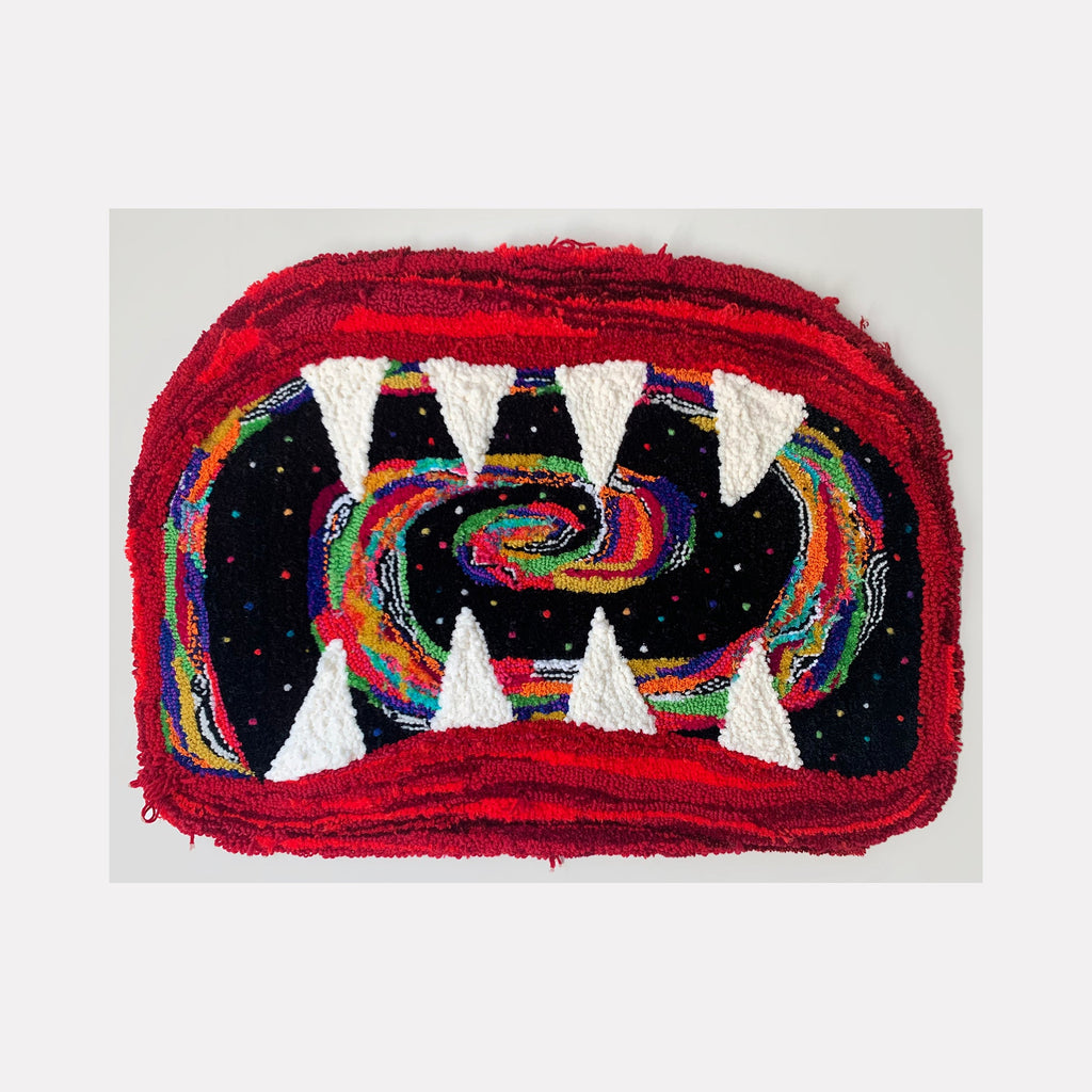 The artwork 'histerica #3, Hystera' by Ana Maria Farina features a vibrant textile composition depicting an abstract mouth-like shape with white triangular teeth against a black background. A swirling rainbow pattern creates a mesmerizing spiral effect within the dark cavity, while a bold red border frames the entire piece. Created using upcycled fibers on monk's cloth, this contemporary fiber art measures 25x34 inches.
