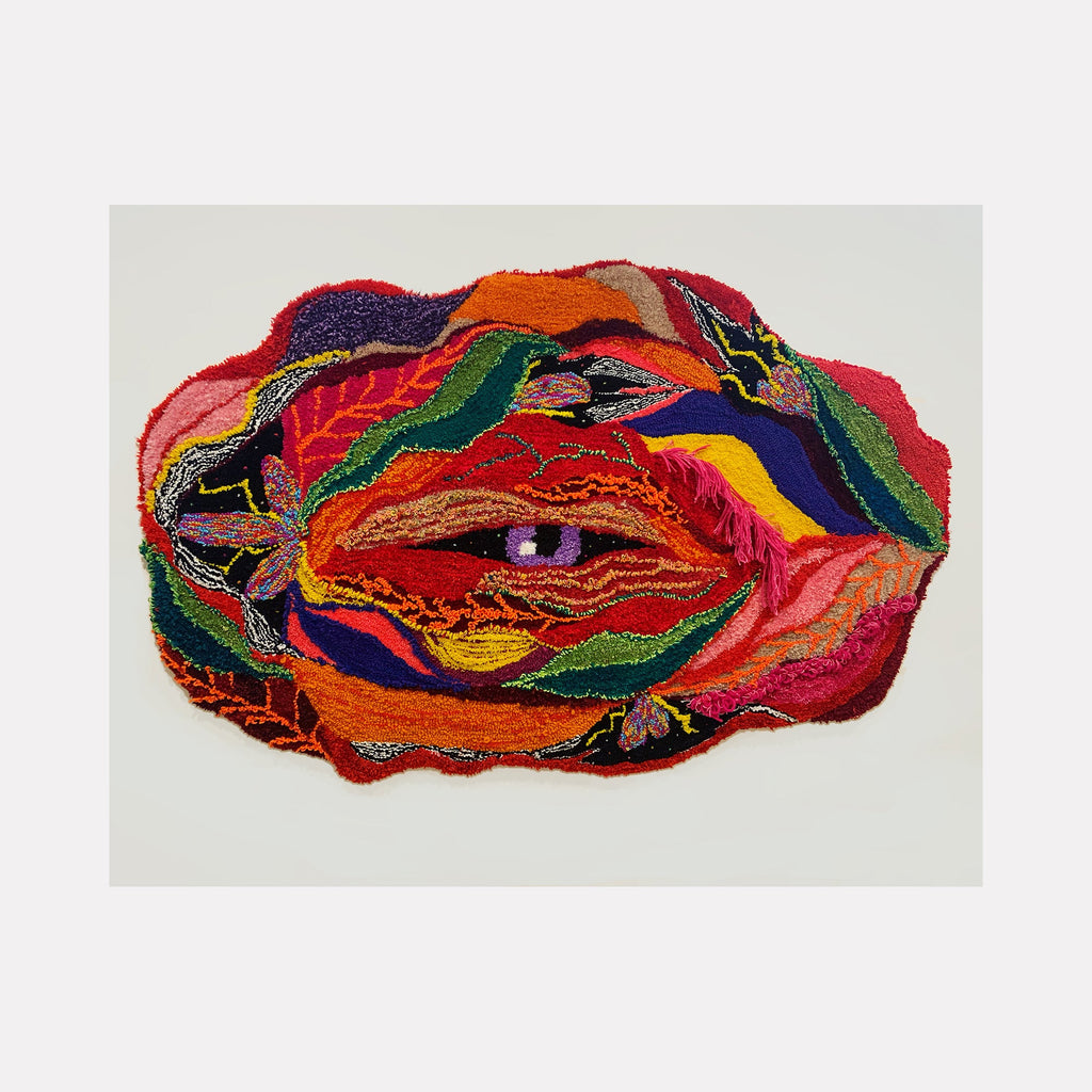 The artwork 'histerica #8, Jardim Secreto' features vibrant layered upcycled fibers creating an abstract organic form dominated by bold reds, oranges, and deep purples. The textile piece showcases intricate embroidery patterns and flowing lines, resembling a mystical eye or portal amid swirling colorful waves on monk's cloth. By Ana Maria Farina.