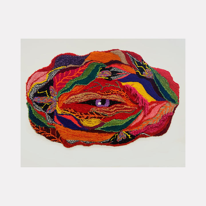 The artwork 'histerica #8, Jardim Secreto' features vibrant layered upcycled fibers creating an abstract organic form dominated by bold reds, oranges, and deep purples. The textile piece showcases intricate embroidery patterns and flowing lines, resembling a mystical eye or portal amid swirling colorful waves on monk's cloth. By Ana Maria Farina.