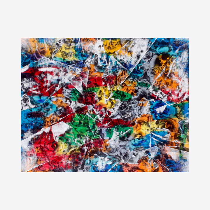 The artwork 'Shattered Garden' by Aaron Hillebrand features an explosive abstract composition with fractured shapes in vibrant colors of turquoise, crimson, emerald, and golden yellow. The mixed media piece showcases dynamic brushstrokes and photo transfer elements, creating a kaleidoscopic effect with layers of texture and movement across the art board surface.