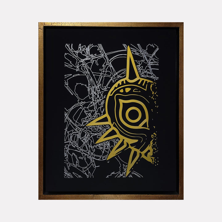 The artwork 'Its Me In The Mask - Gold & Silver Edition' by IvIvI features a striking tribal-style mask design in metallic gold against a black background, with intricate silver line patterns forming an abstract maze-like texture. Framed in rich brown wood, this archival ink piece combines bold geometric shapes with delicate details.
