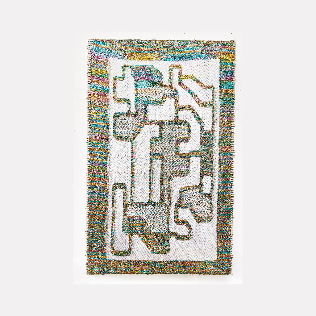 The artwork 'Divine Blueprint' features an abstract geometric composition of interlocking angular shapes woven in iridescent metallic and cotton yarn. The design resembles a maze-like pattern with white negative spaces, bordered by a shimmering multicolored frame that transitions through turquoise, gold, and purple hues. Handwoven textile art by Robin Kang.